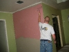 Pat painting the pink wall